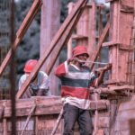 Hardworking construction workers building framework on construction site outdoors.